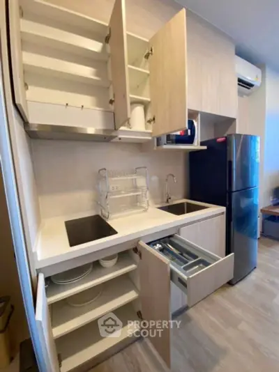 Modern kitchen with sleek cabinetry, induction cooktop, and stainless steel appliances