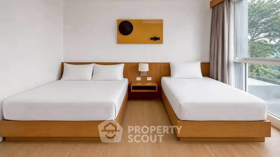 Modern twin bedroom with large window and minimalist decor