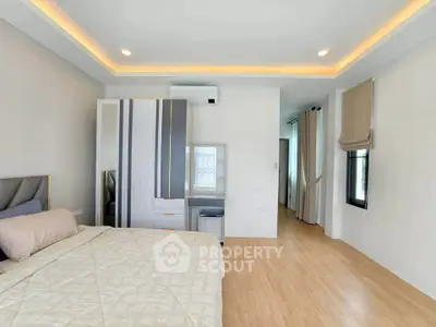 Spacious modern bedroom with elegant lighting and stylish decor