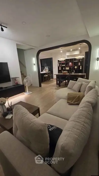 Spacious modern living room with cozy seating and elegant dining area