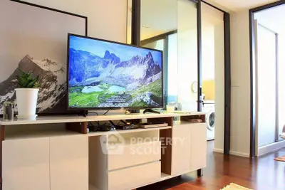 Modern living room with sleek TV setup and sliding glass doors