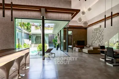 Luxurious open-plan living room with modern decor and pool view