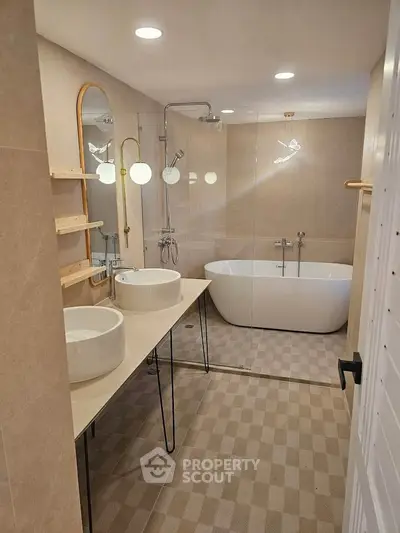 Luxurious bathroom with modern fixtures and elegant freestanding bathtub.