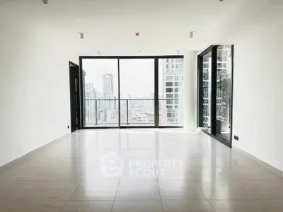Spacious modern living room with large windows offering stunning city views in a high-rise apartment.