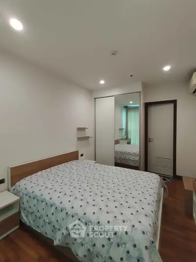 Spacious bedroom with modern decor and ample natural light