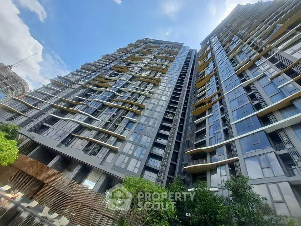 Stunning modern high-rise building with unique architectural design and expansive glass windows.