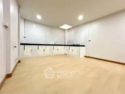 Spacious modern kitchen with sleek design and ample storage in a bright, open layout.