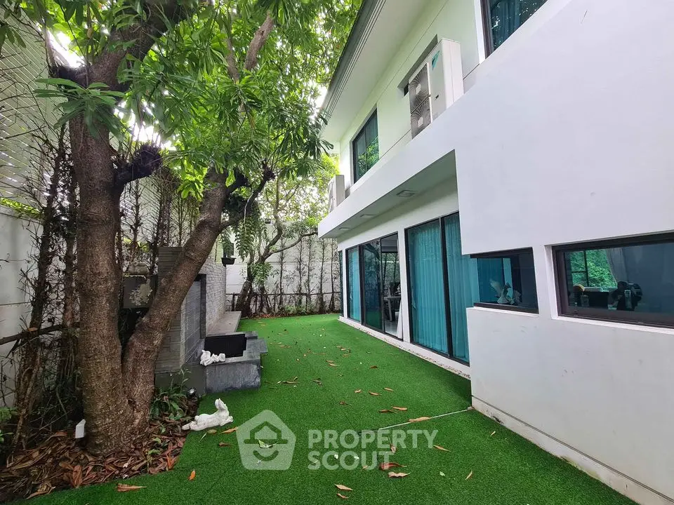 Modern home with lush garden and large windows for natural light