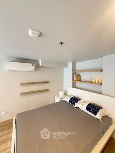 Modern bedroom with minimalist design and air conditioning in a stylish apartment.