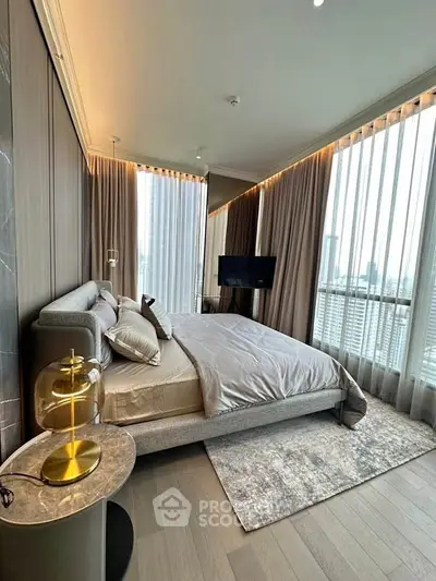 Luxurious bedroom with panoramic city view and elegant decor in modern high-rise apartment.