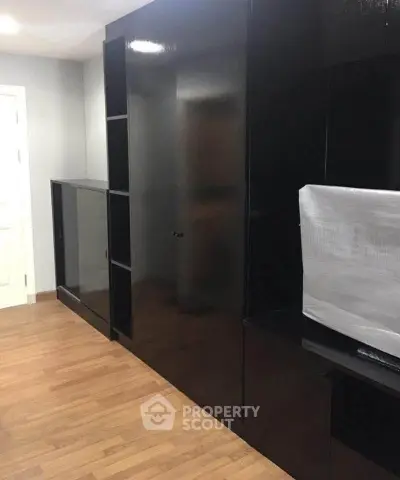 Modern black storage unit with sleek design in a contemporary interior space.