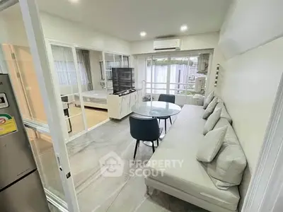 Modern living room with sleek furniture and large windows in a stylish apartment.