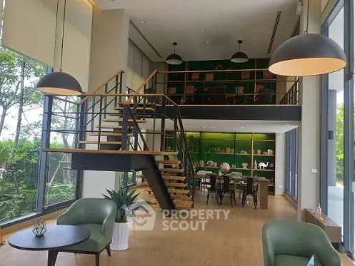 Modern duplex living room with stylish staircase and large windows