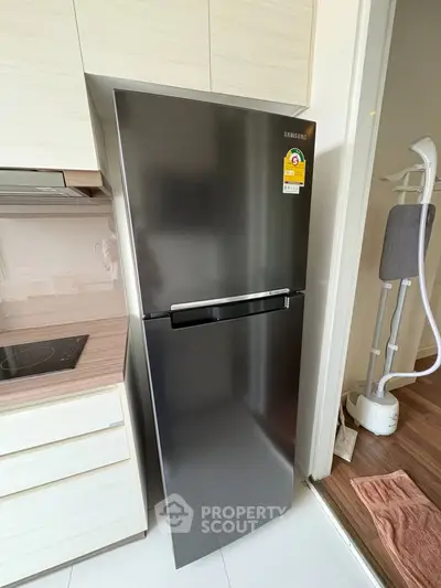Modern kitchen with sleek stainless steel fridge and induction cooktop
