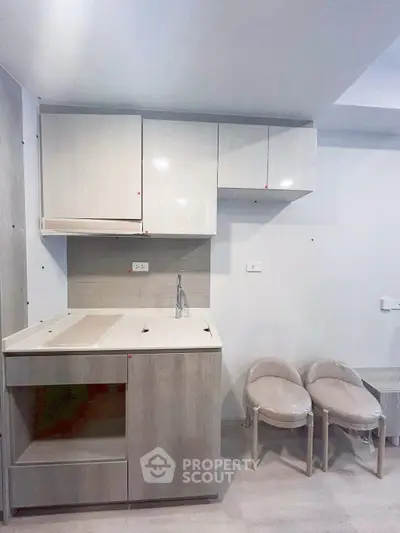 Modern compact kitchen with sleek cabinetry and minimalist design