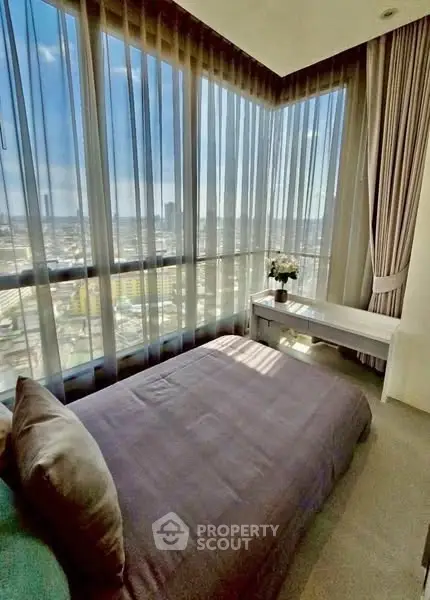 Stunning bedroom with panoramic city views and elegant decor