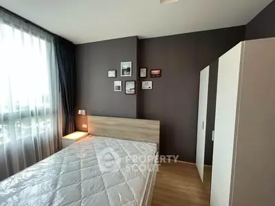 Modern bedroom with stylish decor and ample natural light, featuring a comfortable bed and sleek wardrobe.