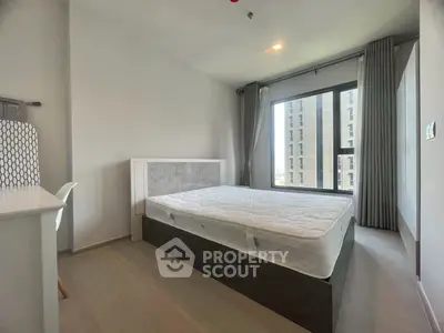 Modern bedroom with large window and minimalist design in urban apartment