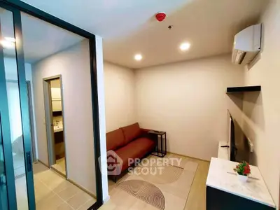Modern living room with sleek design and cozy ambiance, featuring a comfortable sofa and stylish decor.