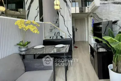 Modern living room with stylish decor and open staircase in a contemporary apartment.