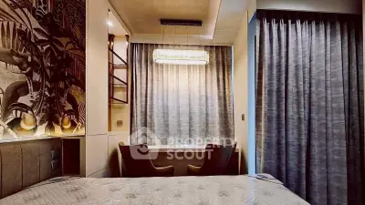 Luxurious bedroom with elegant decor and cozy seating area, perfect for relaxation and comfort.