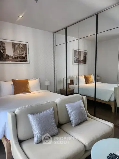 Luxurious modern bedroom with mirrored closet and elegant decor