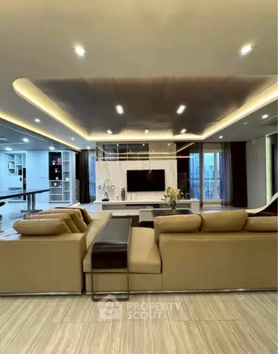 Luxurious modern living room with elegant lighting and spacious seating area.