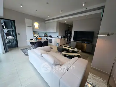 Modern open-plan living room with sleek kitchen and stylish decor