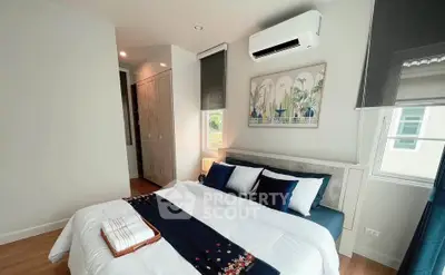 Modern bedroom with stylish decor and air conditioning in a cozy apartment.