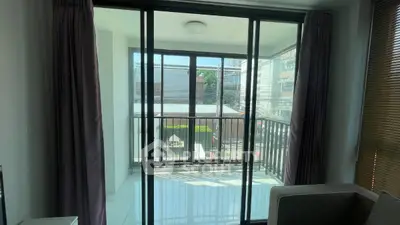 Modern apartment with spacious balcony and large windows offering city views.