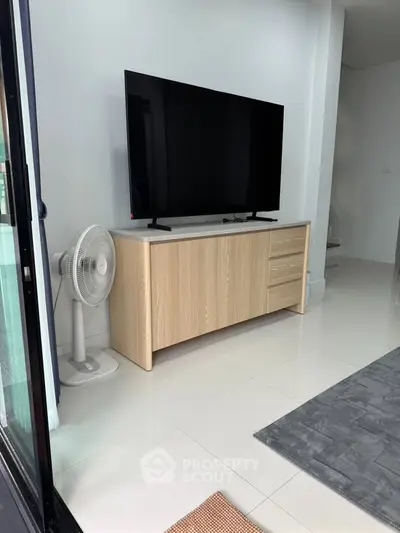 Modern living room with sleek TV setup and stylish wooden cabinet