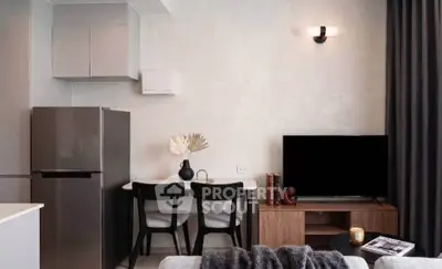 Modern living room with sleek furniture and stylish decor, featuring a compact dining area and contemporary appliances.