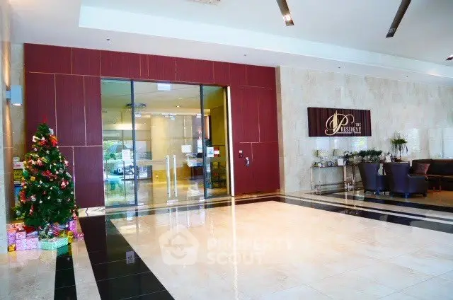 Luxurious building entrance with elegant decor and festive Christmas tree