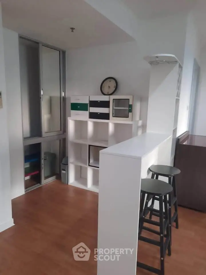 Modern interior with stylish shelving and bar stools, perfect for a cozy living space.