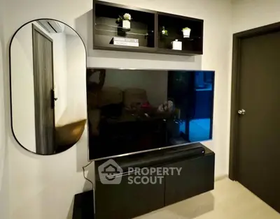 Modern living room with sleek TV setup and stylish shelving