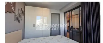 Modern bedroom with sleek wardrobe and stylish decor in a contemporary apartment.