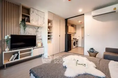 Modern living room with stylish decor and open kitchen layout in a cozy apartment.