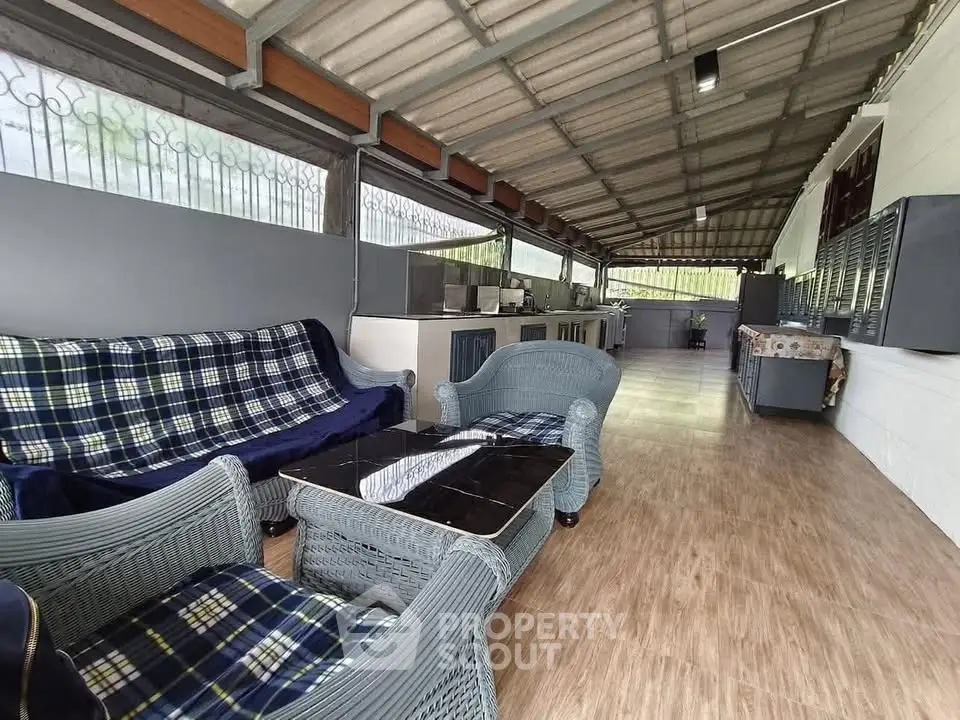 Spacious covered outdoor area with seating and kitchen facilities, perfect for entertaining.