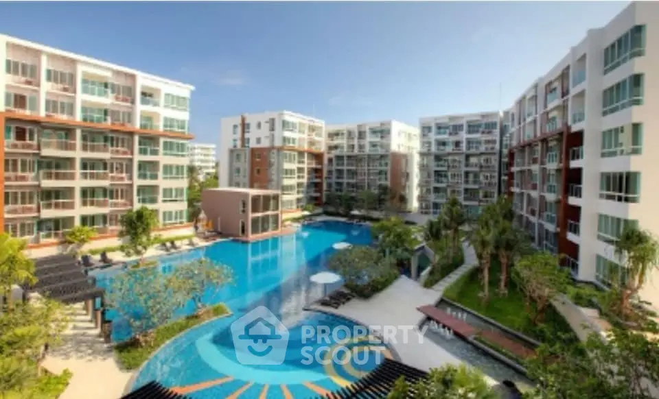 Luxurious condominium complex with stunning pool and landscaped gardens
