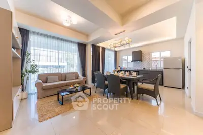 Spacious open-plan living and dining area with modern furnishings and large windows.