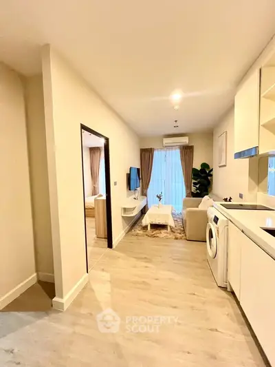 Modern apartment interior with open layout and washing machine