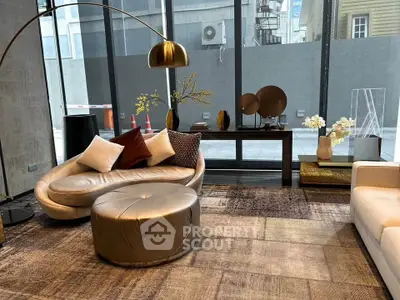 Luxurious modern living room with stylish furniture and large windows offering city views.