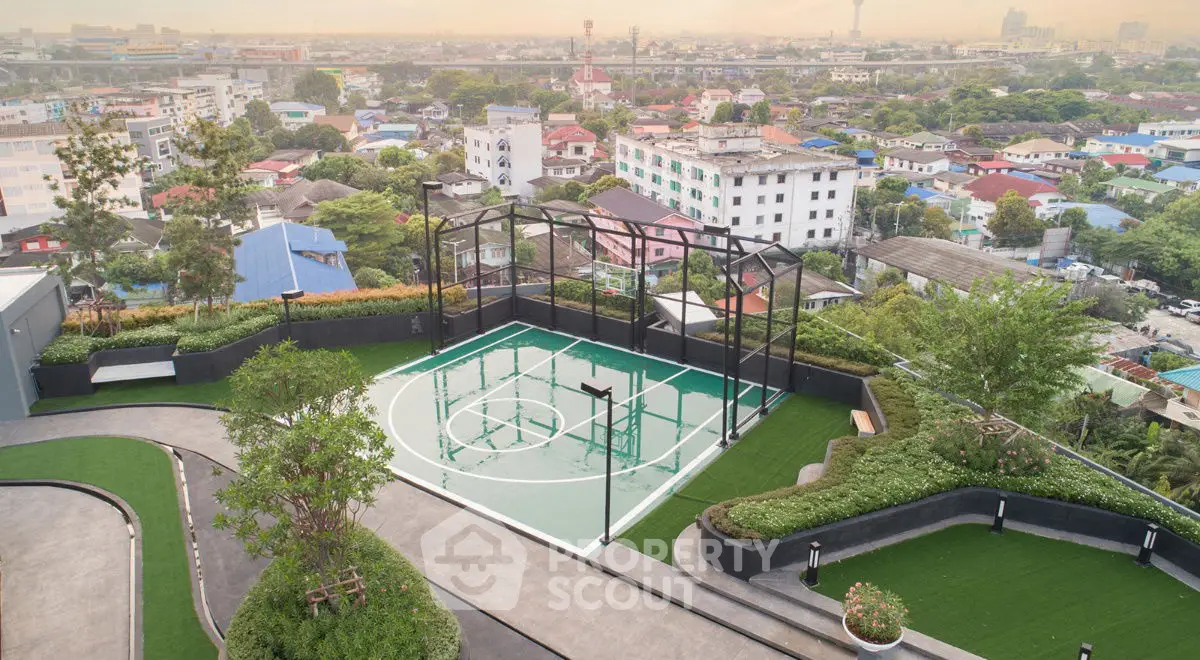 Stunning rooftop basketball court with panoramic city views in urban residential complex.