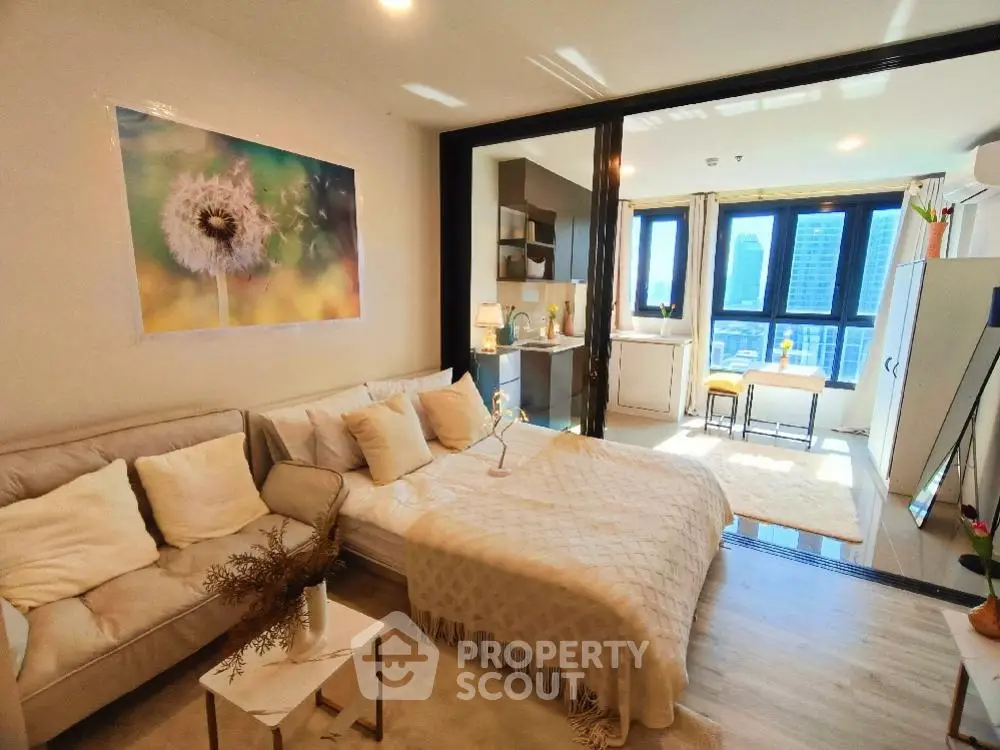 Modern studio apartment with cozy living area and city view