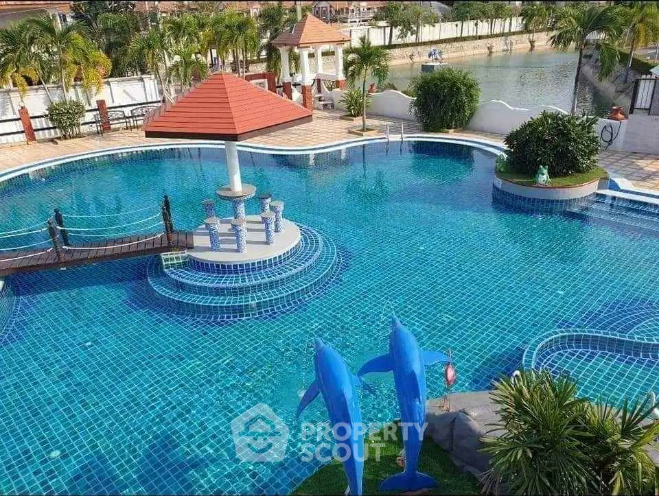 Luxurious swimming pool with unique design and dolphin sculptures, perfect for relaxation and leisure.