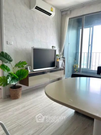 Modern living room with balcony, air conditioning, and stylish decor