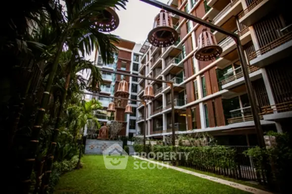 Luxurious modern apartment building with lush garden and unique architectural design.