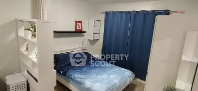 Cozy bedroom with modern decor and blue curtains