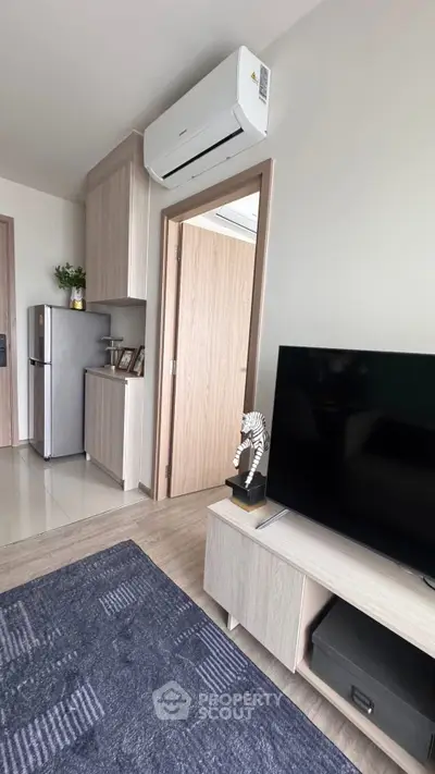 Modern living room with sleek furniture and air conditioning unit