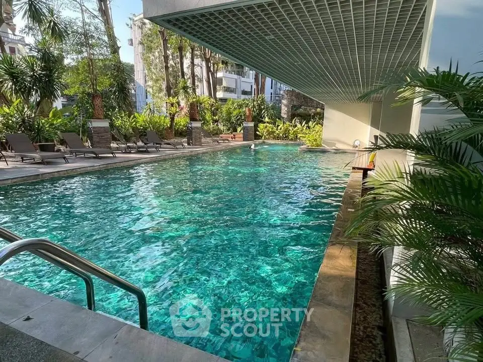 Luxurious pool area with lush greenery and modern design, perfect for relaxation and leisure.